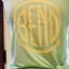 The emblem on Tank top with a yellow disc and a canvas tote with a white one, The Bend Store, May 15, 2019.