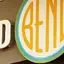 The emblem on The storefront sign, with trucker hats and door stickers carrying small discs, The Bend Store, July 15, 2022.