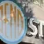 The emblem on Staff group at storefront; BEND disc sign and BEND disc tees in window, The Bend Store, July 6, 2023.