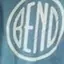 The emblem on Blue long-sleeve tee with a large white disc, in the window, The Bend Store, February 10, 2024.