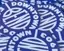 The emblem on Blue circular stickers given away at a Summerfest booth, Downtown Bend Business Association, July 13, 2024.