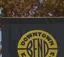 The emblem on Lamp-post banner among the holiday lights, Downtown Bend Business Association, December 5, 2025.
