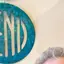 The emblem on Wall discs in blue and white, and ball caps with disc patches, The Bend Store, April 15, 2026.