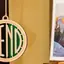 The emblem on A hanging wooden BEND ornament, and a BEND mug, The Bend Store, April 27, 2026.