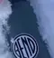 The emblem on A circular vinyl sticker on a water bottle, set in snow to test how it holds, Carstickers.com, July 2, 2026.