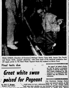 A newspaper photograph of three men crouched over an electrical installation at night, captioned as the Chamber of Commerce manager, a Jaycee and the pageant electrician, above the headline “Great white swan poised for Pageant”.