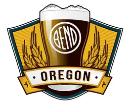 A pint glass topped by the Three Sisters, with a tilted white Bend emblem, barley and an Oregon banner.
