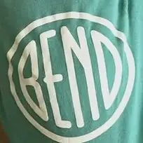 A hand-drawn white disc on green cloth: the word BEND in narrow letters inside a wobbling ring.