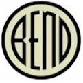 A cream disc with a heavy black ring, the word BEND across it in narrow black letters.