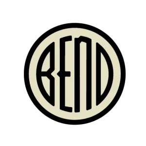 A cream disc with a heavy black ring, the word BEND across it in narrow black letters with an arched third letter.