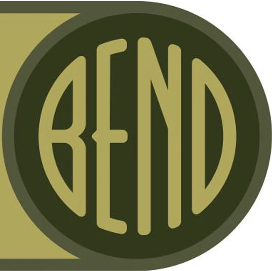 A dark green disc with the word BEND cut out of it in tall narrow gold letters, the third letter a capital N with a diagonal.