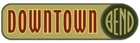 The word DOWNTOWN in red slab letters beside a dark green disc containing BEND in broad gold letters.