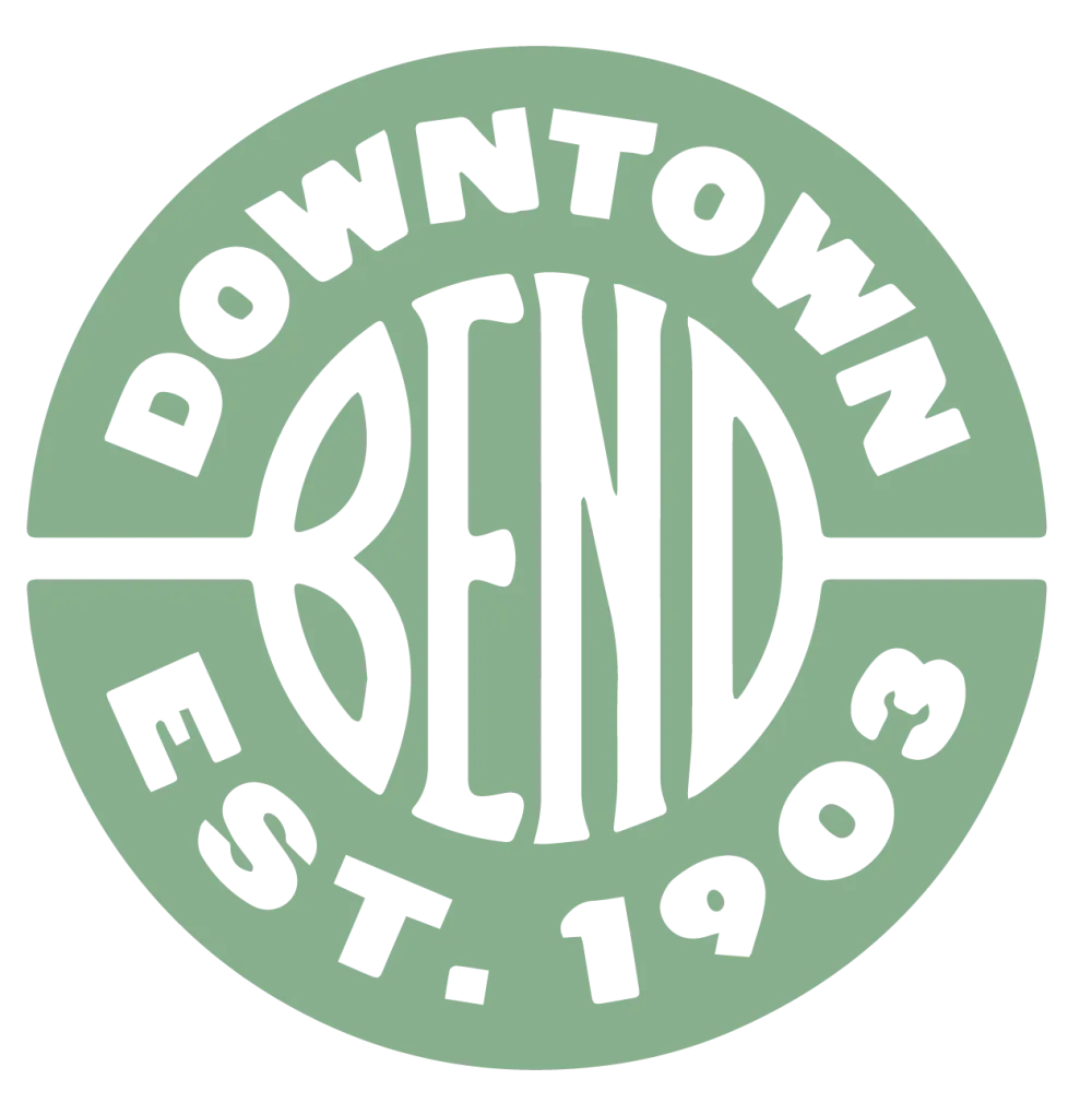 A green circular badge with white BEND letters, DOWNTOWN above and EST. 1903 below.