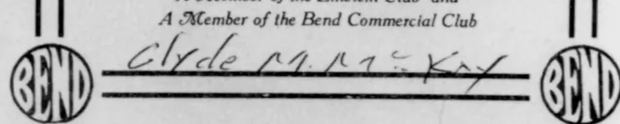 The lower part of a printed page reading GROUP PORTRAIT of A Member of the Emblem Club and A Member of the Bend Commercial Club, with a circular BEND emblem in each bottom corner and a signature in ink between them.
