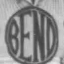 A circular emblem on a knitted sweater, the word BEND filling it in broad letters that run to a thin ring.