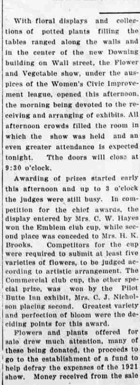 A newspaper column reporting the flower and vegetable show in the new Downing building, recording that Mrs. C. W. Hayes won the Emblem club cup with Mrs. H. K. Brooks second.