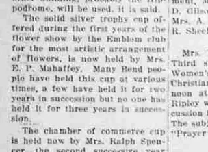 A newspaper paragraph describing the solid silver trophy cup offered by the Emblem club for the most artistic arrangement of flowers, now held by Mrs. E. P. Mahaffey.