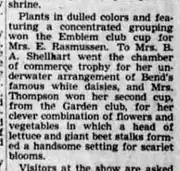 A newspaper paragraph reporting that plants in dulled colors featuring a concentrated grouping won the Emblem club cup for Mrs. E. Rasmussen.