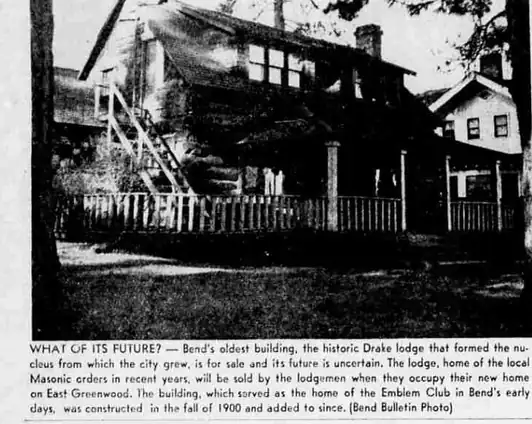 A newspaper photograph of a large wooden lodge behind a picket fence, with a covered porch and an exterior stair, captioned “What of its future?”