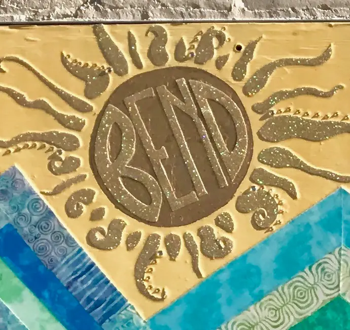 The public artwork and its emblem detail.