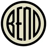 A cream disc with a heavy black ring, the word BEND across it in narrow black letters with an arched third letter.