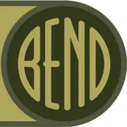 A dark green disc with the word BEND cut out of it in tall narrow gold letters, the third letter a capital N with a diagonal.