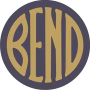 A blue disc with the word BEND in broad gold letters filling the circle.