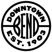 A circular badge with the letters BEND at its centre, drawn in black on white, with lettering curved around the ring.